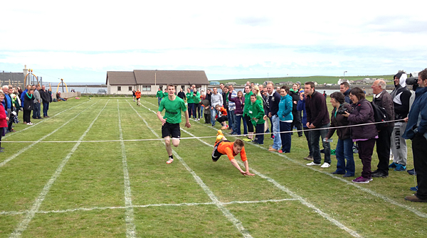 Westray's Owen Rendall takes advantage of Daniel Hourston's trip to win the men's 1500m.