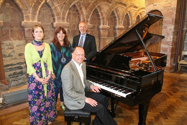 Pictured with the piano from l to r are: Francesca Couperwhite from Highlands and Islands Enterprise, donator Judith Glue and OIC councillor Harvey Johnston. Seated is chairman of the St Magnus Festival Leslie Burgher.