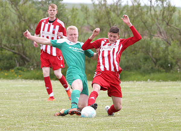 Westray's William Bradley battles with St Andrew's Connan Rendall during Westray's quarter-final victory. Bradley will be hoping to provide the required industry and determination to help Westray reach a first Parish Cup final in six years.