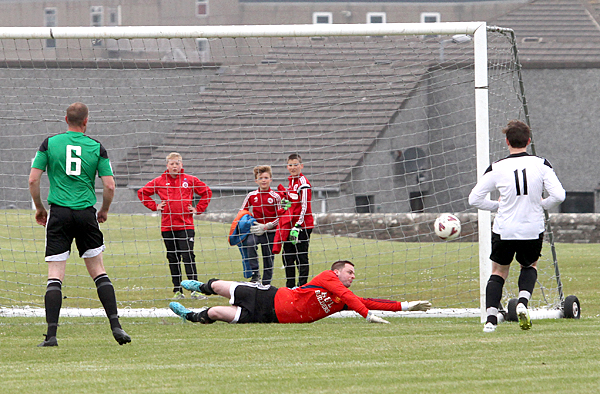 Liam Martin scores for Stromness against St Ola.