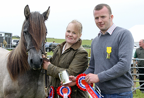 A two-year-old Highland Pony owned by Sarah Campbell won the champion of the yard title at the 'Hope Show. Sarah is pictured being presented with the award by show president Glen Thomson. (www.theorcadianphotos.co.uk)