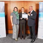 Gail Anderson and Gaynor Jones from Voluntary Action Orkney are pictured receiving a business excellence award from Dave Bradley of Quality Scotland.