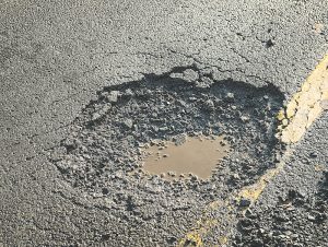 Councillor digs into pothole problem