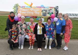 Flower power to the fore for charity bed-pushers