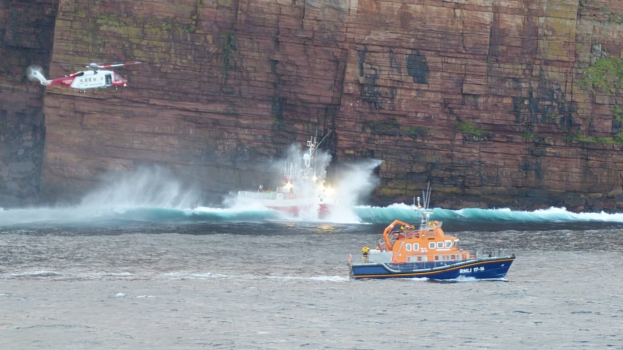 Crew of stricken fishing boat airlifted to safety after hitting rocks close to Orkney landmark